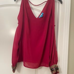 Beautiful blouse with cut out but toon details and embellished cuffs!